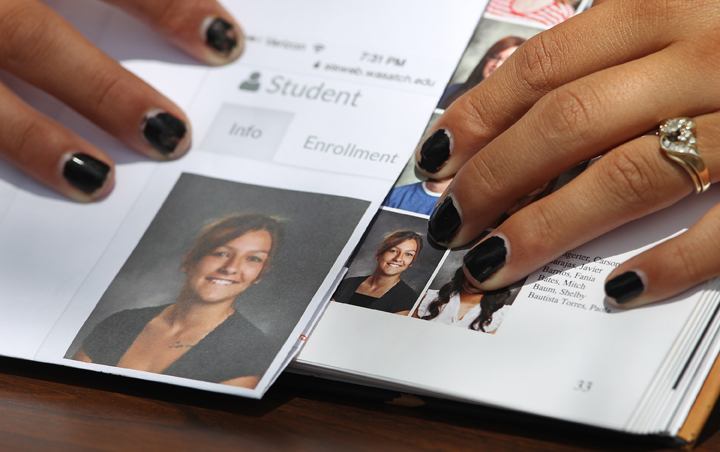 Wasatch High School sophomore Shelby Baum, 16, points to yearbook proof, left, and her altered school yearbook photo, right, Thursday, May 29, 2014, in Heber City, in Utah.
