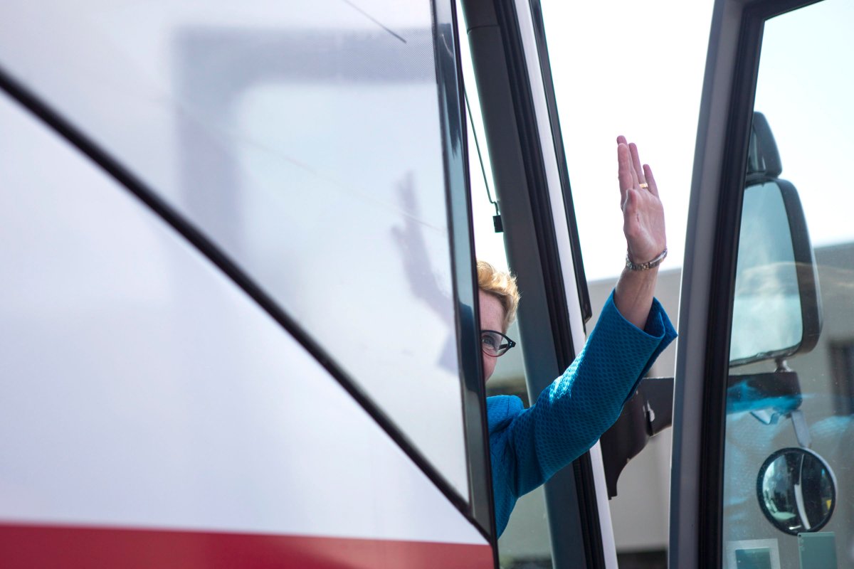 Ontario Premier and Liberal Leader Kathleen Wynne waves goodbye as she boards her campaign bus after touring Cyclone MFG Inc., a company which manufactures parts for the aviation industry, during a campaign stop in Mississauga, Ont., on Tuesday, May 13,.