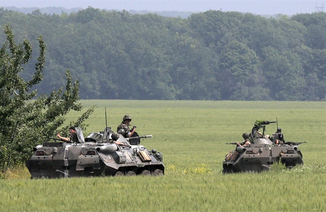 Members of the Ukrainian army inspect an area near Slovyansk, Ukraine, Friday, May 30, 2014. 