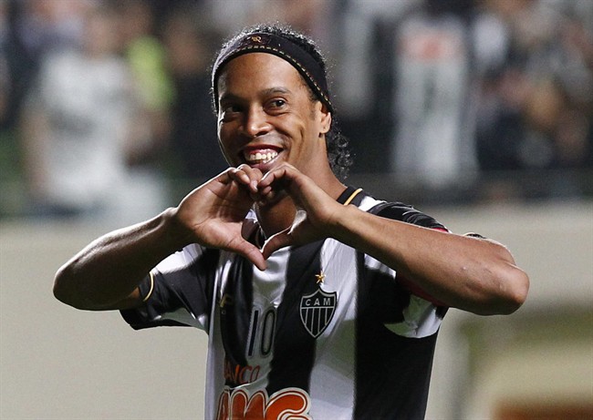 FILE - In this July 11, 2013 file photo, Brazil's Atletico Mineiro's Ronaldinho celebrates his team's victory over Argentina's Newell's Old Boys at the end of a Copa Libertadores semifinal soccer match in Belo Horizonte, Brazil. The Brazilian soccer midfielder is putting his Rio de Janeiro mansion on the rental market during the last half of the World Cup. The real estate agency handling the property says on its website that the five-bedroom house is available for the first 15 days of July for $15,522 a day. (AP Photo/Bruno Magalhaes, File)