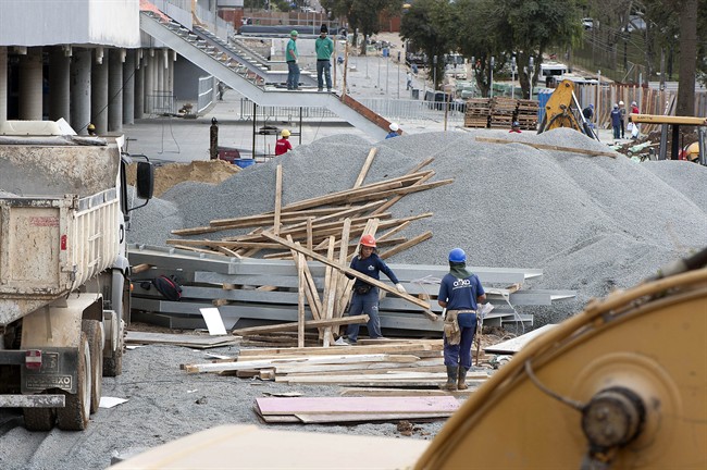 This May 9, 2014 shows that work continues at the Arena da Baixada in Curitiba, Brazil. It's all coming down to the final 30 days. Brazil had seven years to get ready for the World Cup, but it enters the final month of preparations with a lot yet to be done. The unfinished stadium in Brazil's southern city of Curitiba, was nearly excluded from the tournament by FIFA earlier this year. (AP Photo/Denis Ferreira Netto)
