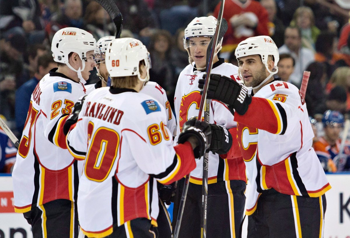 Calgary Flames Sean Monahan (23), Markus Granlund (60), Joe Colborne (8) and Mark Giordano (5) celebrate a gaol against the Edmonton Oilers during first period NHL hockey action in Edmonton, Alta., on Saturday March 1, 2014. 