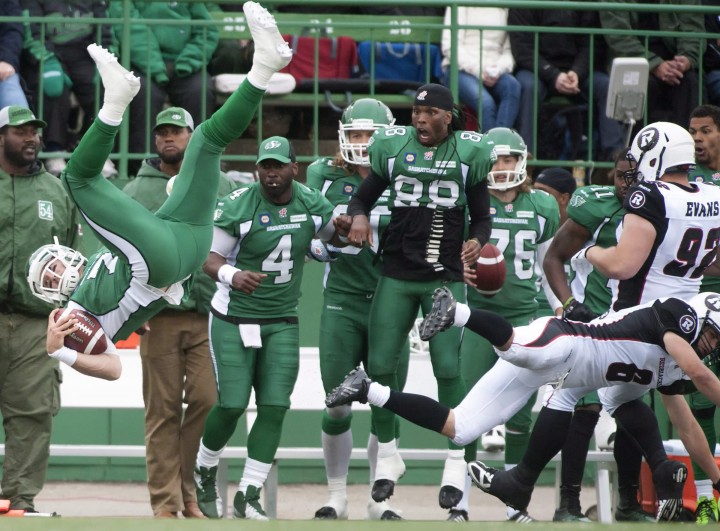 The Saskatchewan Roughriders bench reacts as their quarterback Seth Doege flips though the air after taking a hit from Ottawa Redblacks defensive back Antoine Pruneau during the second half of CFL pre-season football action in Regina, Sask.,