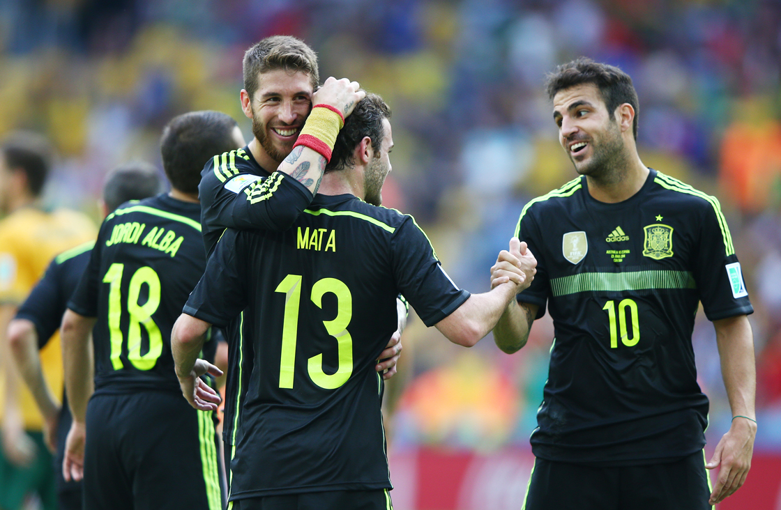 CURITIBA, BRAZIL - JUNE 23: Juan Mata of Spain (C) celebrates scoring his team's third goal with teammates Sergio Ramos (L) and Cesc Fabregas during the 2014 FIFA World Cup Brazil Group B match between Australia and Spain at Arena da Baixada on June 23, 2014 in Curitiba, Brazil. (Photo by Ian Walton/Getty Images)
