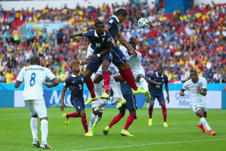 PORTO ALEGRE, BRAZIL - JUNE 15: Paul Pogba of France goes up for a header during the 2014 FIFA World Cup Brazil Group E match between France and Honduras at Estadio Beira-Rio on June 15, 2014 in Porto Alegre, Brazil.