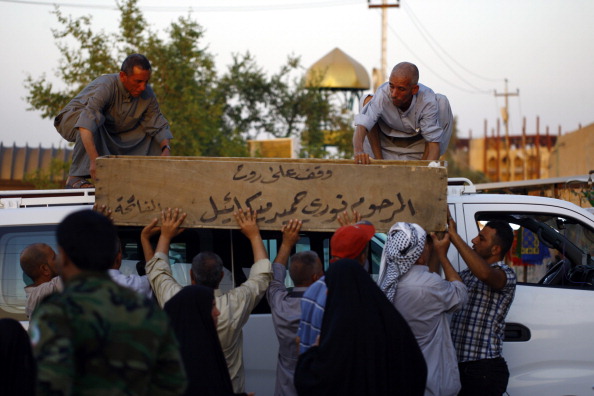 Iraqi mourners carry the coffin of a volunteer fighter who was killed during clashes with militants of the Islamic State of Iraq and the Levant (ISIL) in city of Samarra, during his funeral, on June 26, 2014, in the central shrine city of Najaf. 