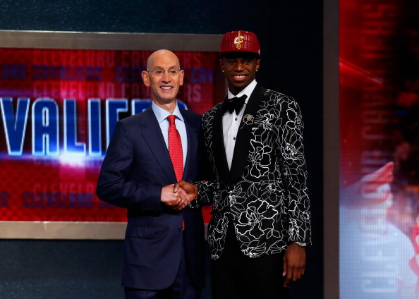 Andrew Wiggins (R) of Kansas poses for a photo with NBA Commissioner Adam Silver after Wiggins was drafted #1 overall in the first round by the Cleveland Cavaliers during the 2014 NBA Draft at Barclays Center on June 26, 2014 in the Brooklyn borough of New York City. (Photo by Mike Stobe/Getty Images).