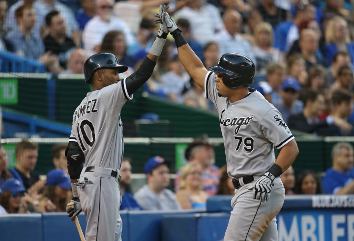 Jose Abreu #79 of the Chicago White Sox is congratulated by Alexei Ramirez #10 after hitting a solo home run in the fifth inning during MLB game action against the Toronto Blue Jays on June 27, 2014 at Rogers Centre in Toronto, Ontario, Canada. (Photo by Tom Szczerbowski/Getty Images).