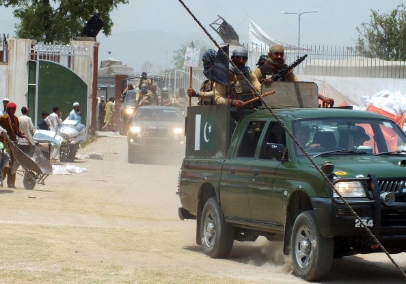 Pakistani troops patrol at a relief distribution point established for internally displaced Pakistani civilans fleeing a military operation against Taliban militants in the North Waziristan tribal agency in Bannu on June 28, 2014. 