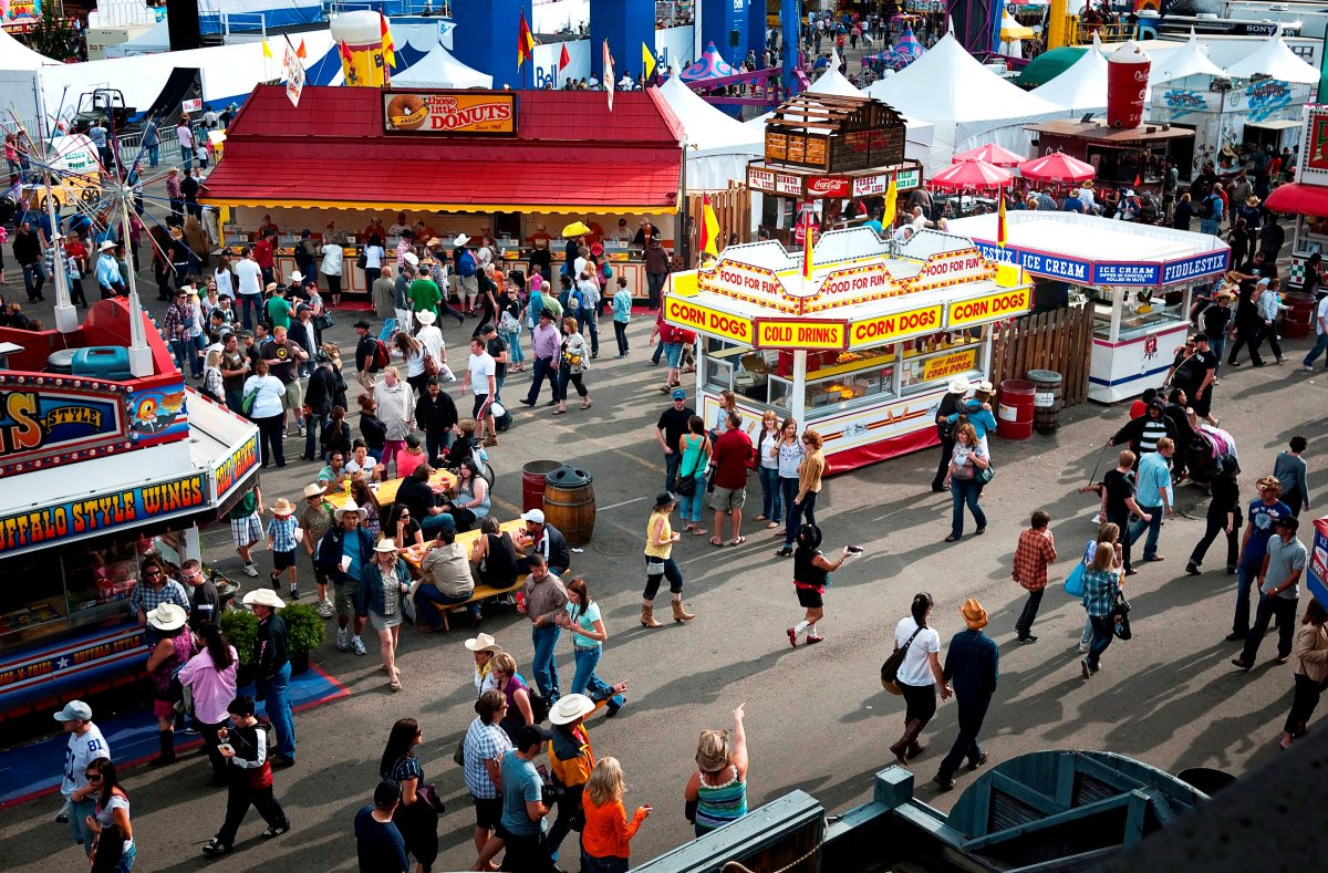 Visitors stroll the food stalls at the Calgary Stampede in Calgary, Sunday, July 18, 2010. The Stampede features ten days of rodeo action, chuckwagon races, livestock competitions and a midway.