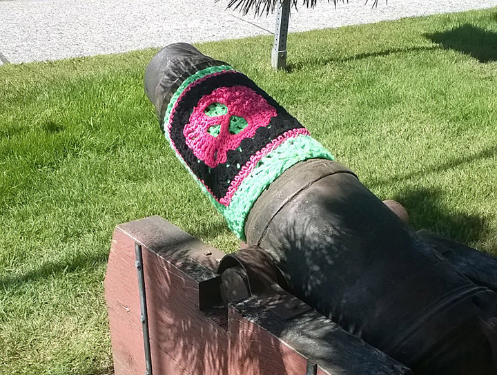 In this June 12, 2014 photo provided by Fran Hartman,a cannon is covered with a skull made of yarn, in Sitka, Alaska.