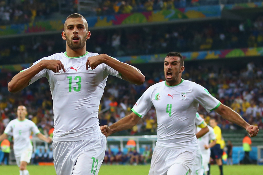 CURITIBA, BRAZIL - JUNE 26: Islam Slimani of Algeria (L) celebrates scoring his team's first goal with Essaid Belkalem during the 2014 FIFA World Cup Brazil Group H match between Algeria and Russia at Arena da Baixada on June 26, 2014 in Curitiba, Brazil. (Photo by Julian Finney/Getty Images)