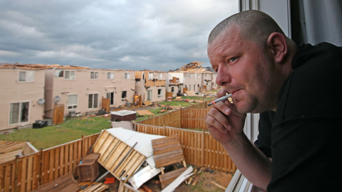 Kenny Gies observes the damage to his neighbour's homes from the upstaris of his home on Banting Crescent in Angus, Ontario on Tuesday June 17, 2014.