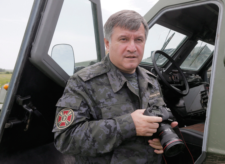 Ukrainian Interior Minister, Arsen Avakov, inspects an Ukrainian Army Dozor-B armored Scout Car in a landfill at Chuguev, Ukraine, Wednesday, June 4, 2014. 