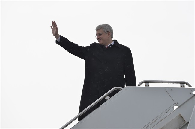 Prime Minister Stephen Harper boards a plane heading to Poland in Ottawa, Tuesday June 3, 2014 . 