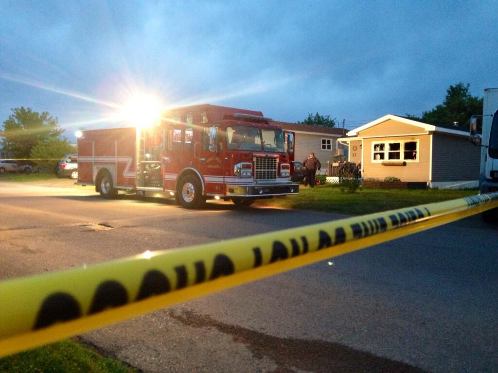 A fire truck sits outside the scene of a fatal fire in Bible Hill, N.S. on June 10, 2014.