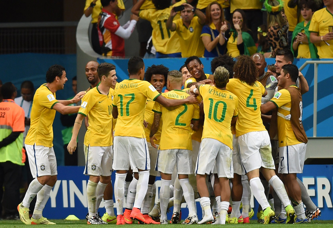 Brazil's players celebrate after scoring a fourth goal during a Group A football match between Cameroon and Brazil at the Mane Garrincha National Stadium in Brasilia during the 2014 FIFA World Cup on June 23, 2014. AFP PHOTO / PEDRO UGARTE (Photo credit should read PEDRO UGARTE/AFP/Getty Images)