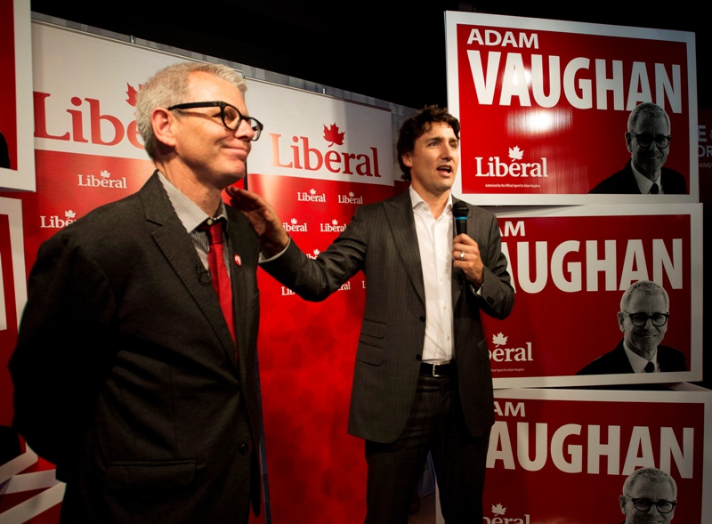 Federal Liberal leader Justin Trudeau, right, speaks to supporters with candidate for the Trinity-Spadina riding Adam Vaughan, left, during a campaign stop in Toronto on Thursday, May 22, 2014. THE CANADIAN PRESS/Nathan Denette.