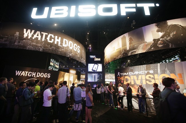 This June 12, 2013 file photo shows attendees waiting in line for presentations on the video games, "Watch Dogs" and "Tom Clancy's The Division" at the Ubisoft booth during the Electronic Entertainment Expo in Los Angeles. 