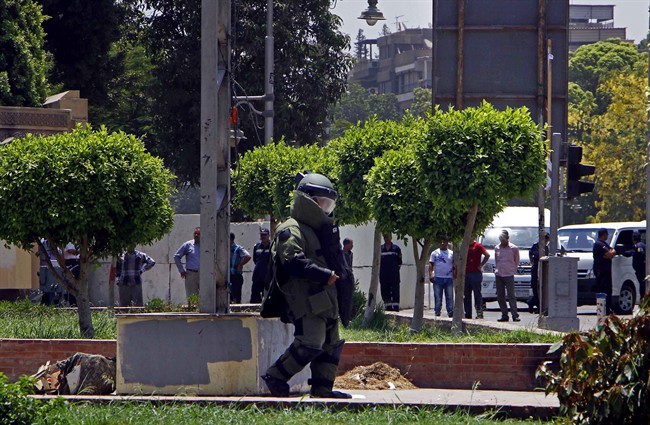 Egyptian security forces inspect the scene after two homemade bombs went off near the presidential palace in Cairo, Egypt, Monday, June 30, 2014. 