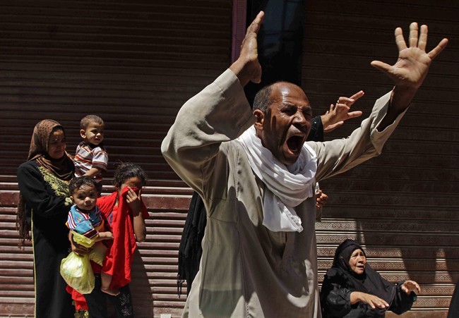 Relatives of a Muslim Brotherhood member who was sentenced to death react to the verdict outside a courtroom in Minya, Egypt, Saturday, June 21, 2014.