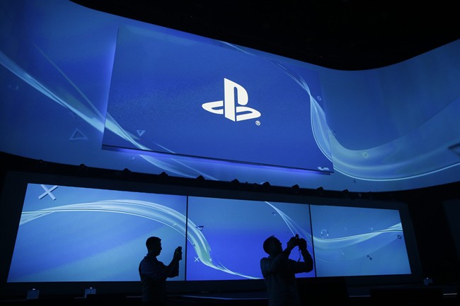 Attendees take pictures at the Sony's Playstation presentation ahead of the Electronic Entertainment Expo on Monday, June 9.