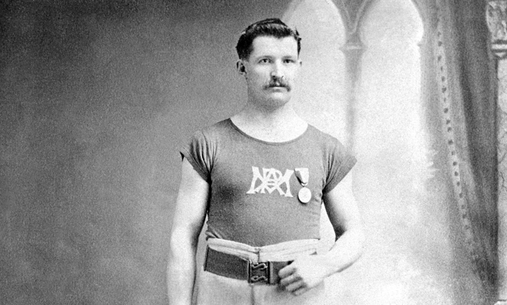 Canada’s Etienne Desmarteau poses with his gold medal won in the shot put event at the 1904 St. Louis Olympics.