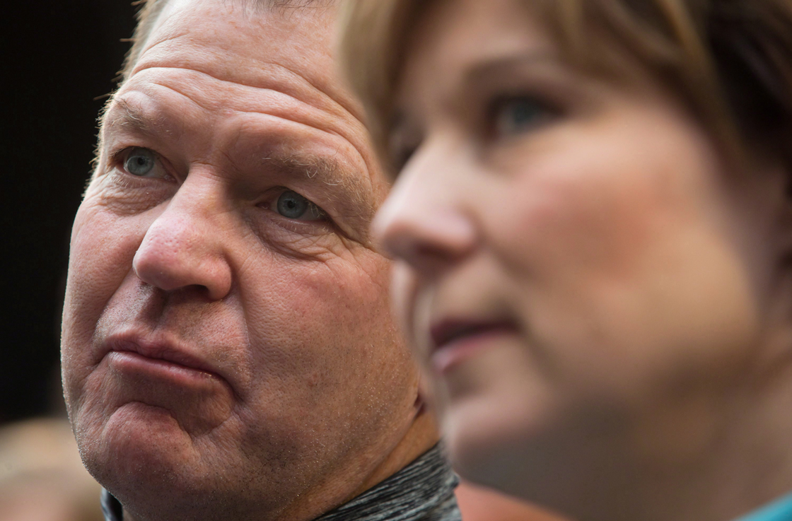Lululemon Athletica Inc. founder and Chairman of the Board Chip Wilson, left, sits with British Columbia Premier Christy Clark during an announcement at Kwantlen Polytechnic University in Richmond, B.C., on Friday December 7, 2012.