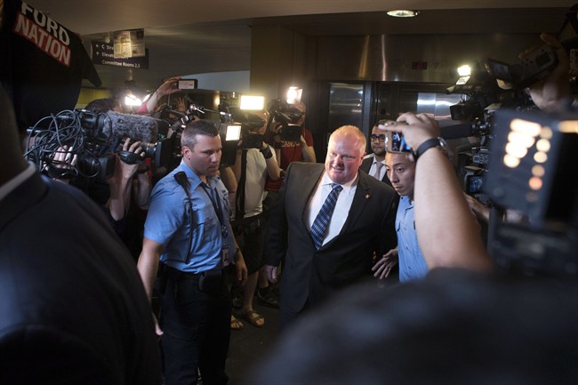 Toronto Mayor Rob Ford is greeted by a media throng as returns to his office at city hall in Toronto on Monday June 30, 2014,