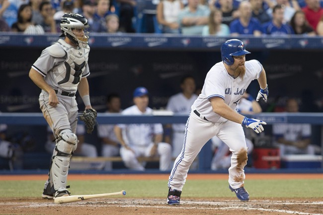 Toronto Blue Jays' Adam Lind runs towards first base after he hits a two run single as Chicago White Sox catcher Adrian Nieto looks on during fourth inning AL baseball action in Toronto on Thursday June 26, 2014. (AP Photo/The Canadian Press, Chris Young).