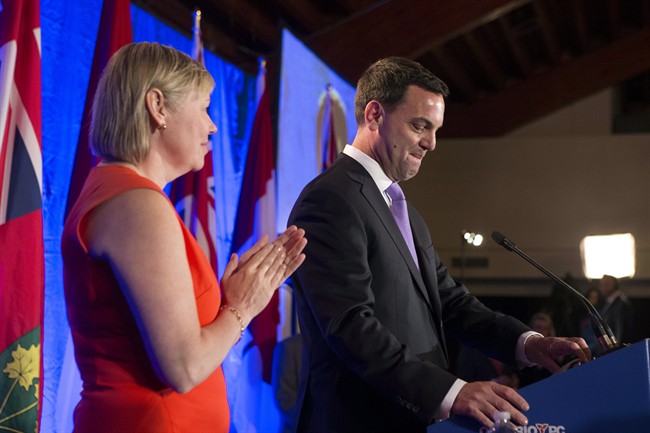 FILE- Former Ontario PC Leader Tim Hudak (right) stands with his wife Deb Hutton as he gives his concession speech at his election night party in Grimsby, Ontario on Thursday June 12, 2014. THE CANADIAN PRESS/Chris Young.
