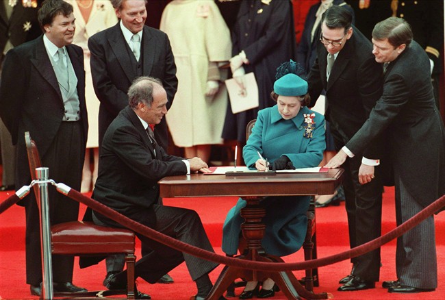 The Queen signs Canada’s constitutional proclamation in Ottawa on April 17, 1982 as Prime Minister Pierre Trudeau looks on.