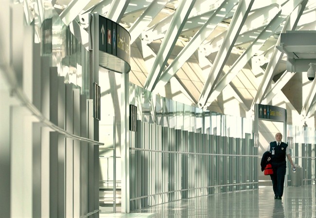 A woman walks through Pearson International Airport on April 6, 2004. THE CANADIAN PRESS/Aaron Harris.