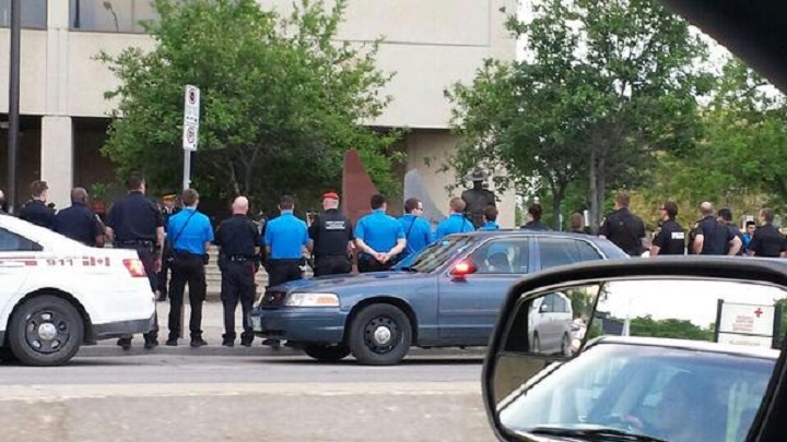 Winnipeg police officers and cadets, Military Police officers and others pay tribute at
RCMP D Division HQ in Winnipeg to fallen Moncton Mounties on Thursday, June 5, 2014.