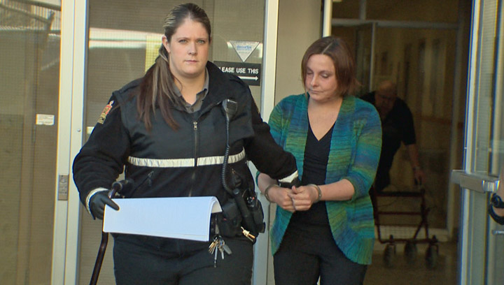 Danielle Fast-Carlson is led from court after being convicted in one of the largest fraud cases in Saskatchewan.