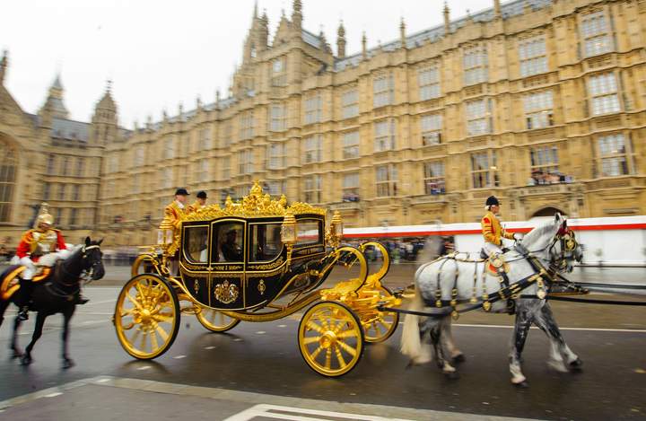 Queen Elizabeth II arrives aboard the new Diamond Jubilee Coach to attend the State Opening of Parliament at the House of Lords, London Wednesday June 4, 2014.