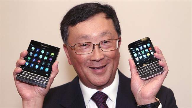 BlackBerry CEO John Chen shows off the new Passport (left) and Classic phone models after the company's Annual General Meeting in Waterloo, Ont., Thursday June 19, 2014.