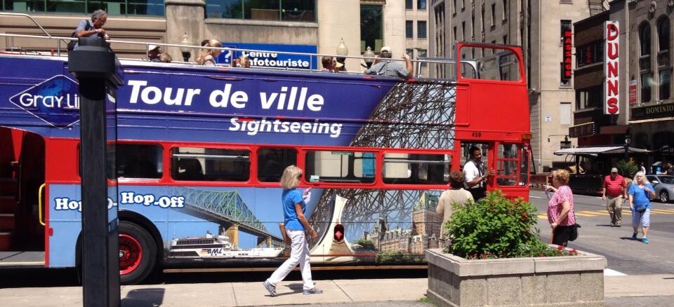 A double-decker tour bus in downtown Montreal.