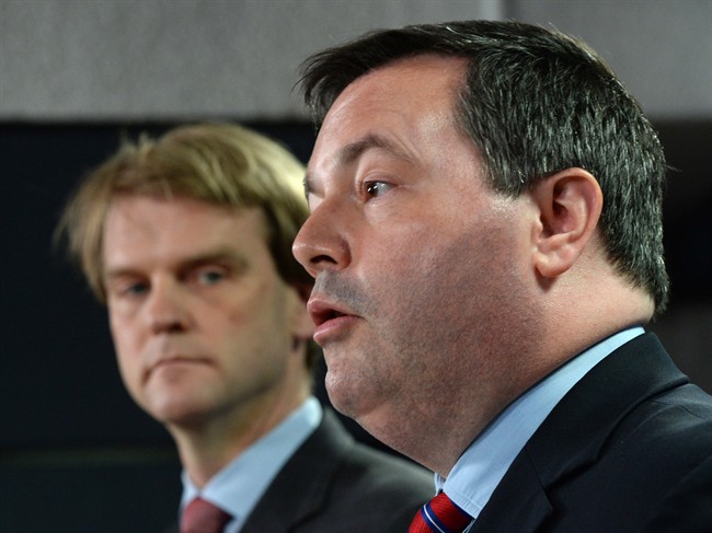 Employment Minister Jason Kenney speaks at a news conference in Ottawa on Friday, June 20, 2014 on reforms to the Temporary Foreign Worker Program. Citizenship and Immigration Minister Chris Alexander is seen in background.