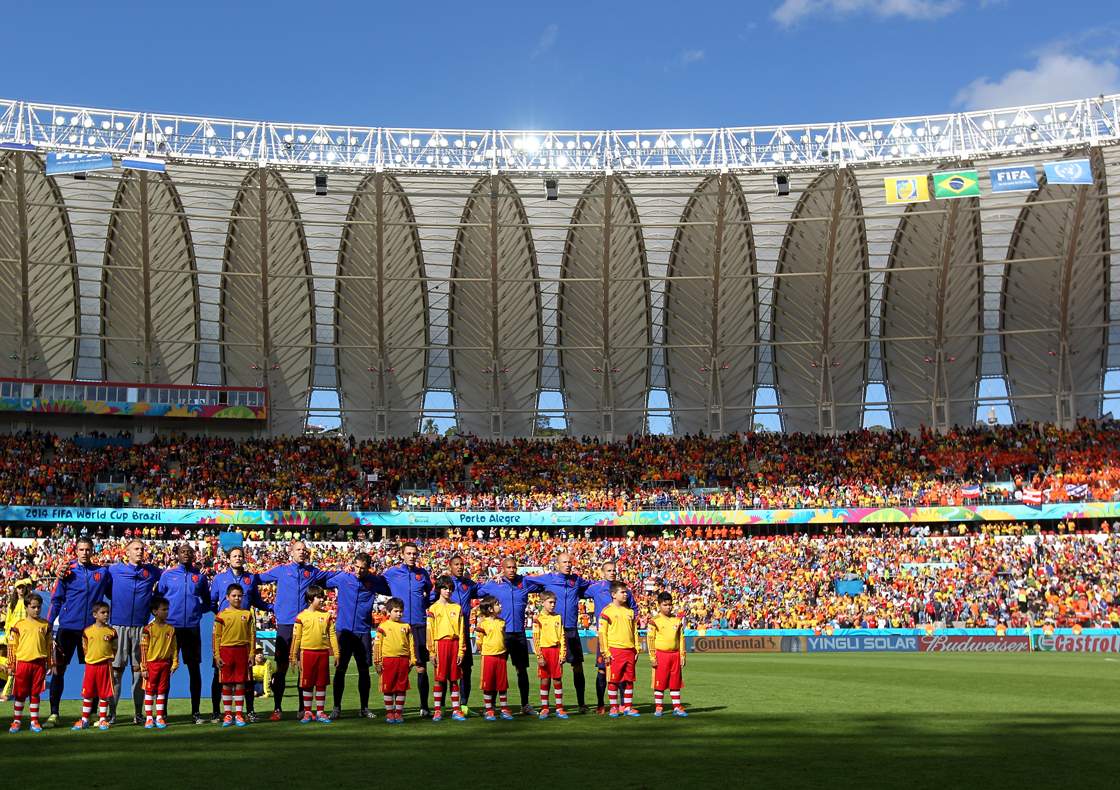 PORTO ALEGRE, BRAZIL - JUNE 18: The Netherlands players line up on the field before the 2014 FIFA World Cup Brazil Group B match between Australia and Netherlands at Estadio Beira-Rio on June 18, 2014 in Porto Alegre, Brazil. (Photo by Dean Mouhtaropoulos/REMOTE/Getty Images)
