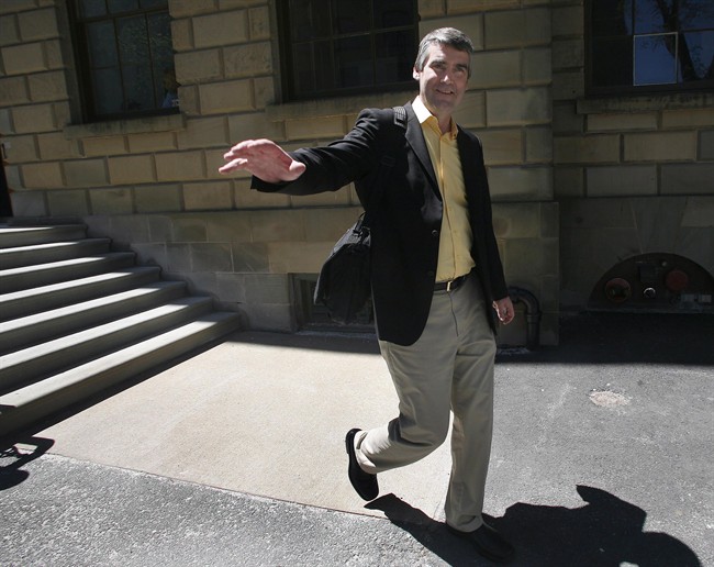 File - Nova Scotia Premier Stephen McNeil waves to a passerby as he leaves Province House in Halifax following a press conference on Tuesday, June 3, 2014,.