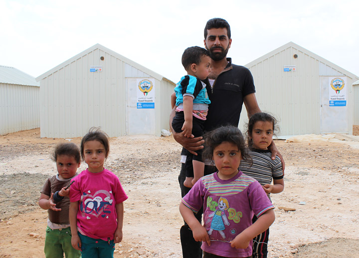 Kamal Khsheat poses with his five children in Azraq camp