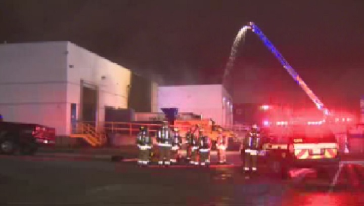 Crews work to contain a warehouse fire in Woodbridge on June 12, 2014.