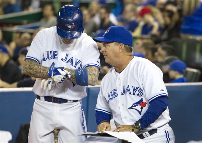 Toronto Blue Jays hitting coach Kevin Seitzer (right) talks to player Brett Lawrie before he hits in Toronto, April 9, 2014. 