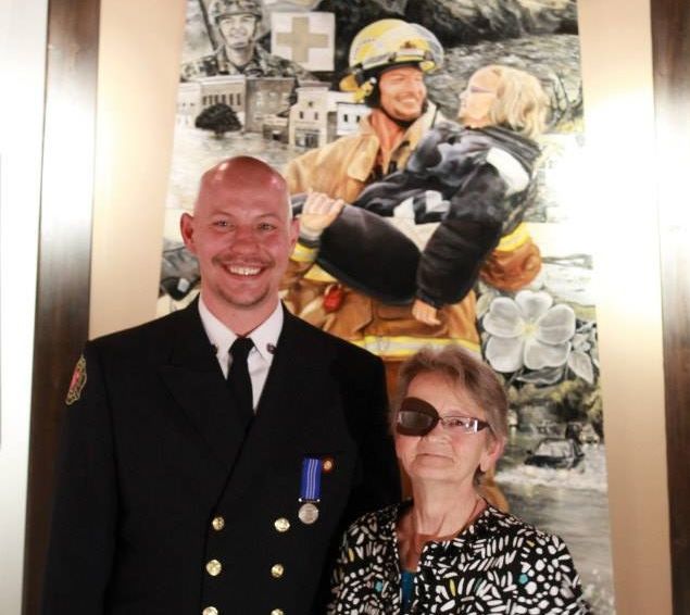 Firefighter Shawn Wiebe still smiling, one year after iconic flood photo - image