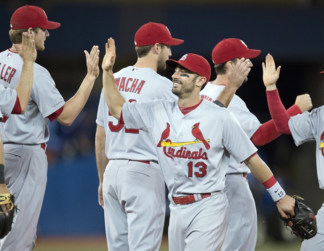 St. Louis Cardinals Matt Carpenter (13) celebrates with teammates after defeating the Toronto Blue Jays 5-0 in interleague action in Toronto on Sunday June 8, 2014. THE CANADIAN PRESS/Frank Gunn.