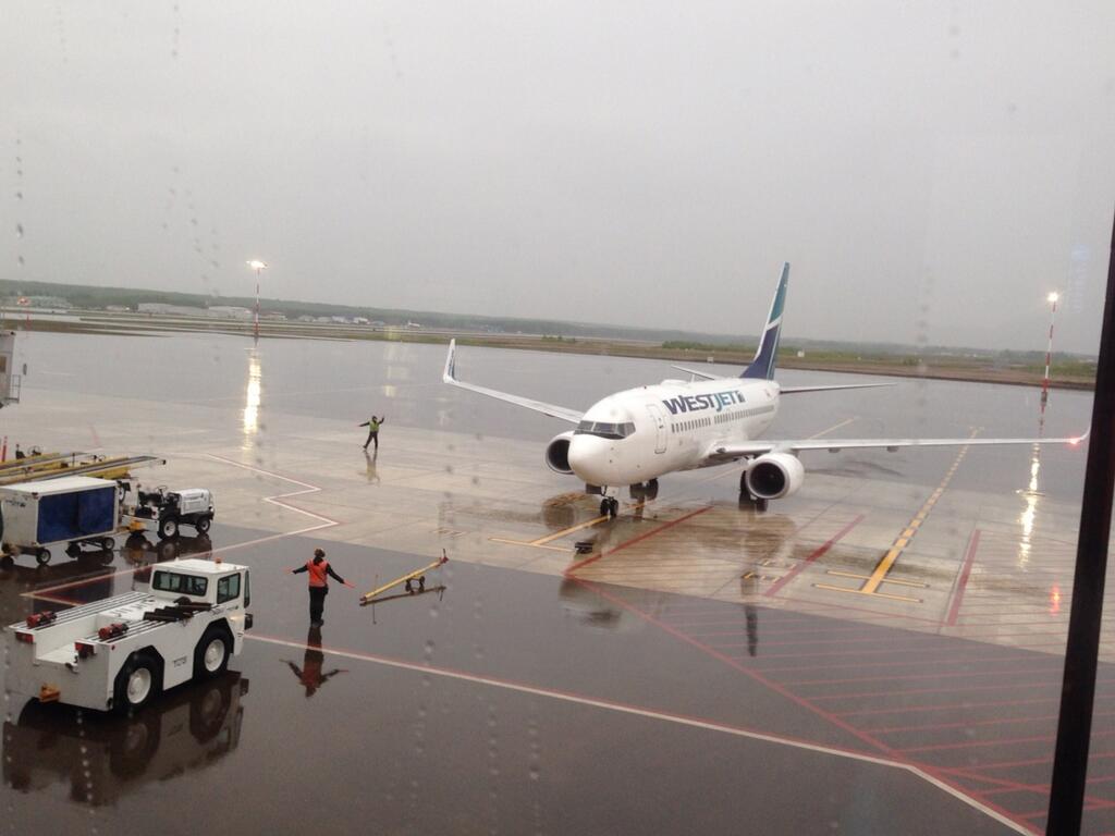 First flight arrives at Fort McMurray's new international terminal, Monday, June 9, 2014. 