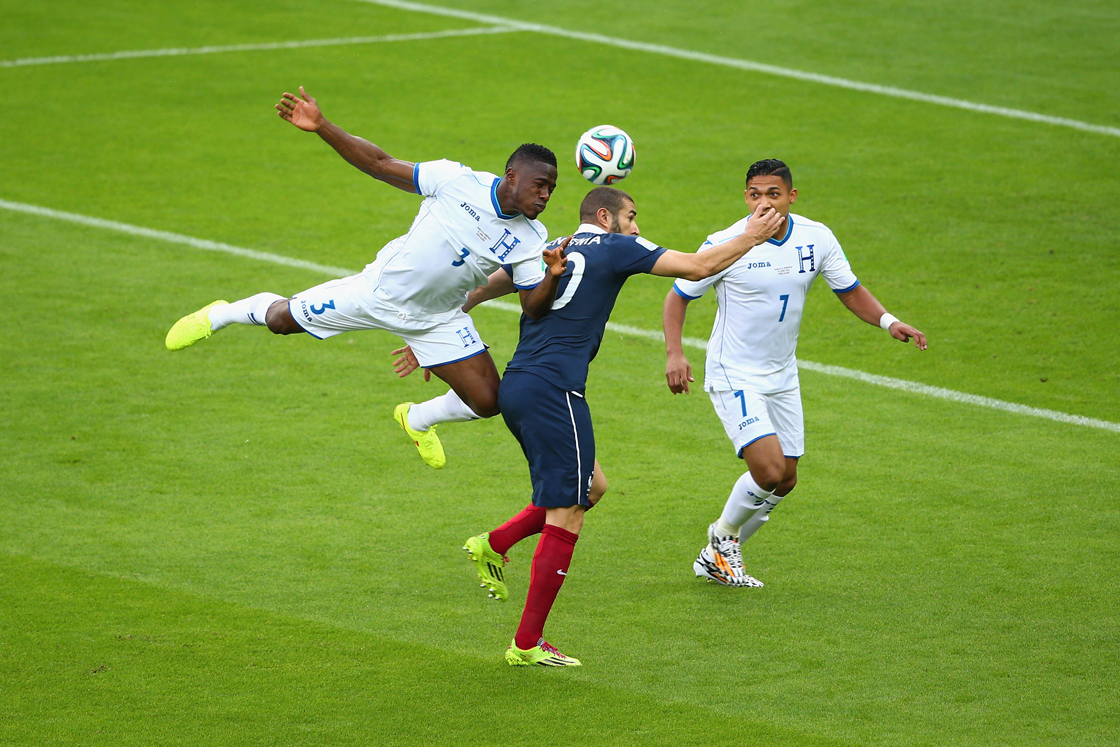 PORTO ALEGRE, BRAZIL - JUNE 15: Patrice Evra of France lies on the field as teammates Antoine Griezmann (2nd L) and Karim Benzema look on with referee Sandro Ricci during the 2014 FIFA World Cup Brazil Group E match between France and Honduras at Estadio Beira-Rio on June 15, 2014 in Porto Alegre, Brazil. (Photo by Paul Gilham/Getty Images)