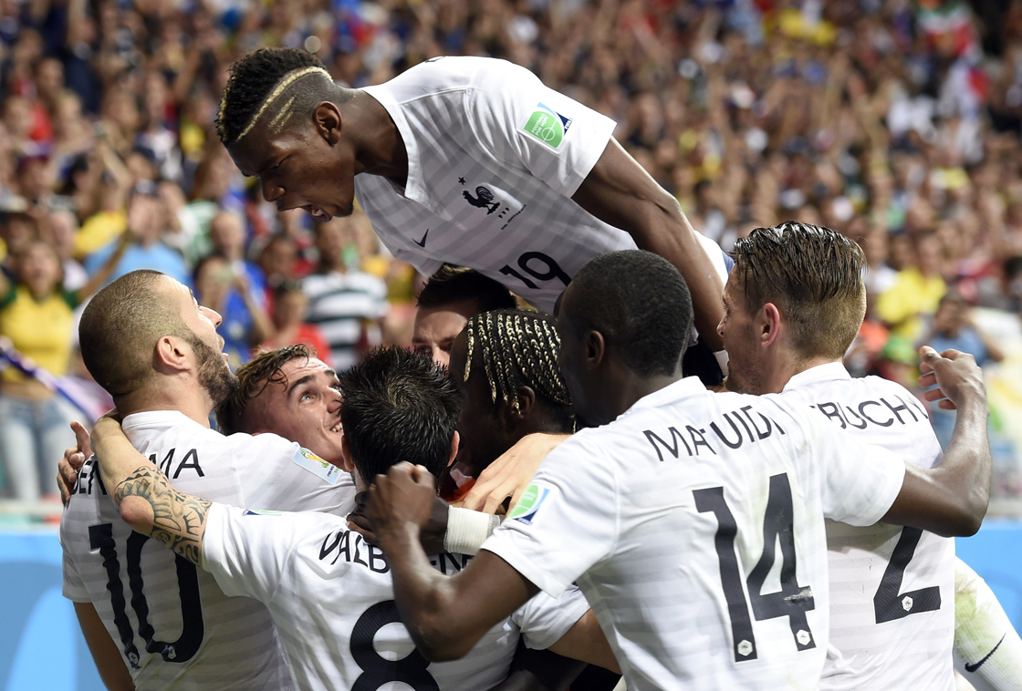 France's forward Paul Pogba celebrates with teammates after scoring during a Group E football match between Switzerland and France at the Fonte Nova Arena in Salvador during the 2014 FIFA World Cup on June 20, 2014. AFP PHOTO / FRANCK FIFE (Photo credit should read FRANCK FIFE/AFP/Getty Images)