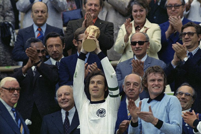 In this July 7, 1974 file photo, West Germany captain, Franz Beckenbauer, holds up the World Cup trophy after his team defeated the Netherlands by 2-1, in the World Cup soccer final at Munich's Olympic stadium, in West Germany.  (AP Photo/File).